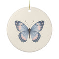 Personalized butterfly memorial ornament, front: a hand-painted butterfly in dusty blue and soft blush