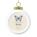 Personalized butterfly memorial Christmas ball, front: a hand-painted butterfly, In Loving Memory Of, the name Karen, 1958 - 2025 and still with me