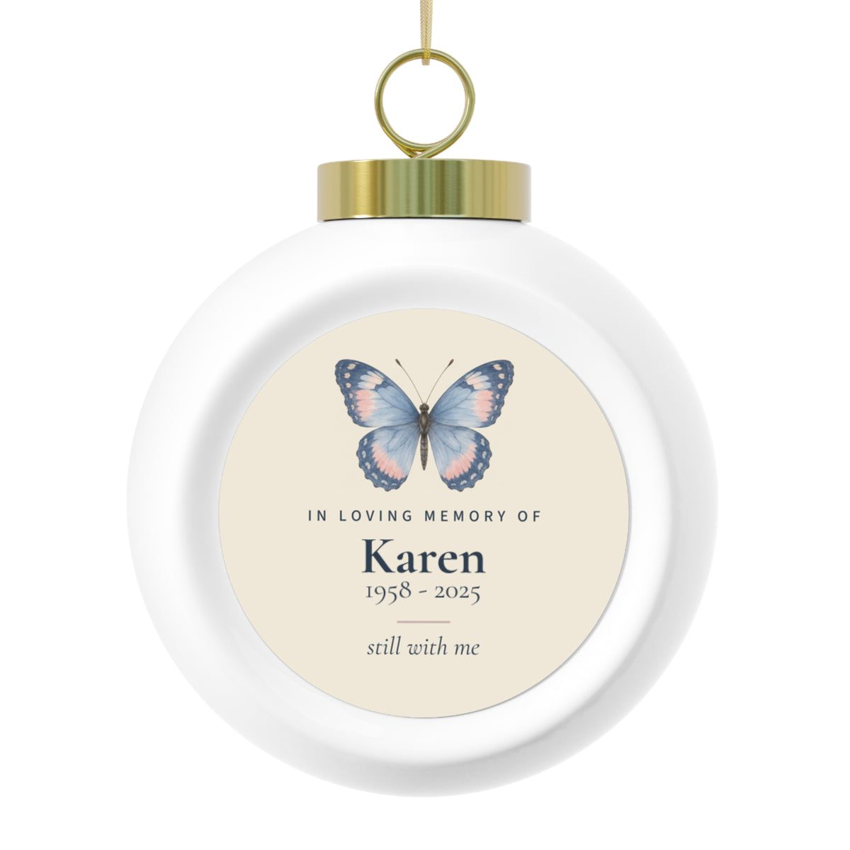 Butterfly memorial Christmas ball with the name Karen and 1958 - 2025, shown with its gold cap
