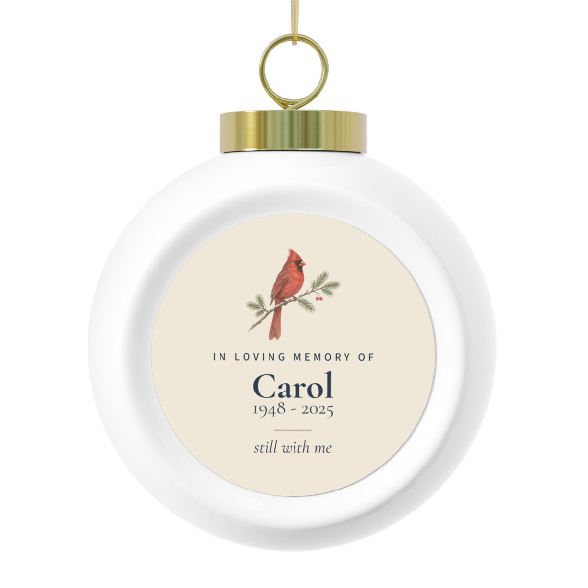 Cardinal memorial Christmas ball with the name Carol and 1948 - 2025, shown with its gold cap