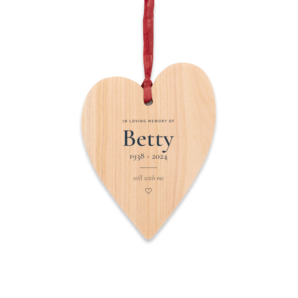 Personalized wooden heart memorial ornament with In Loving Memory Of, the name Betty, 1938 - 2024 and still with me, on a red ribbon